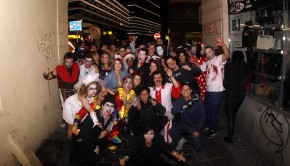 Group photo of Madhouse party hostel guests in costume and ready to party.